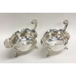 A large pair of silver sauce boats with card cut r