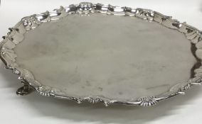 A large Georgian silver pie crust salver on three