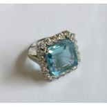 An Art Deco aquamarine and diamond cluster ring in
