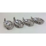A heavy set of four scallop shaped silver salts of