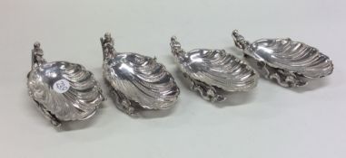 A heavy set of four scallop shaped silver salts of