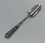 An American silver cheese scoop embossed with flow