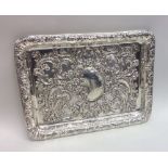 An Edwardian chased silver dressing table tray. Bi