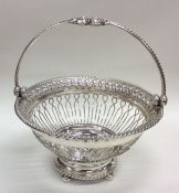 A George III swing handled silver basket with gadr