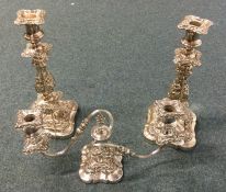 A pair of silver plated embossed candlesticks. Est
