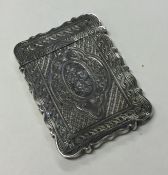 A Victorian silver card case attractively decorate