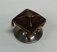 An unusual silver pin cushion mounted with Crown a