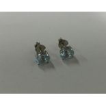 A pair of topaz single stone ear studs in claw mou