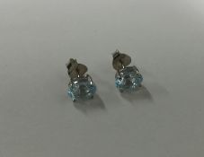 A pair of topaz single stone ear studs in claw mou