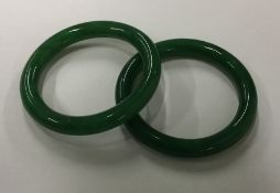 Two green hardstone bangles. Approx. 111 grams. Es