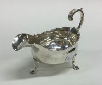 An early Georgian silver sauceboat with shaped car