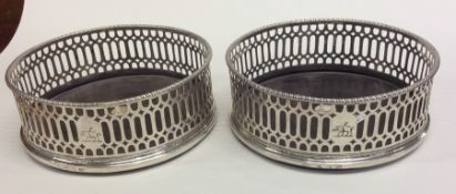 A good pair of pierced Georgian silver coasters wi