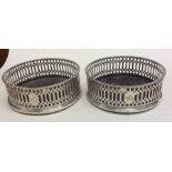 A good pair of pierced Georgian silver coasters wi