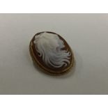 A 9 carat oval cameo with rope twist border. Appro
