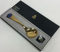 GEORG JENSEN: A cased silver and enamelled spoon.