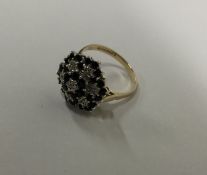 A sapphire and diamond circular cluster ring in cl