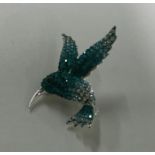 A stylish silver brooch in the form of a bird with