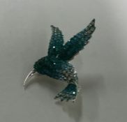 A stylish silver brooch in the form of a bird with