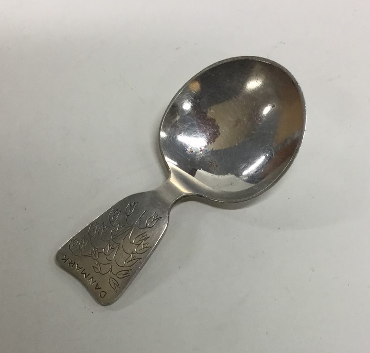 A Danish silver caddy spoon with floral decoration