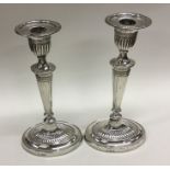 A pair of Edwardian silver candlesticks of taperin