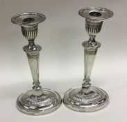 A pair of Edwardian silver candlesticks of taperin