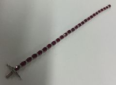 An attractive diamond and ruby line bracelet with