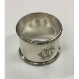 A wide silver Russian napkin ring with beadwork bo