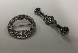 A silver Celtic brooch together with one other. Ap