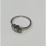 A diamond three stone crossover ring in platinum c