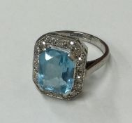 A stylish aquamarine and diamond cluster ring with