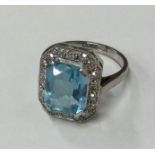 A stylish aquamarine and diamond cluster ring with