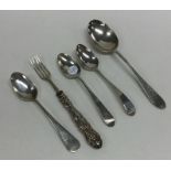 An Edwardian silver spoon together with other silv