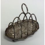An Edwardian silver five bar toast rack with chase