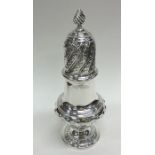 A tall silver sugar caster of half fluted design.