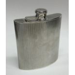 A large silver engine turned hip flask with hinged