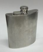 A large silver engine turned hip flask with hinged