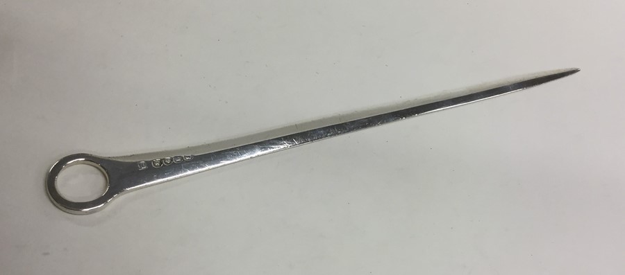 A Georgian crested silver meat skewer with ring te