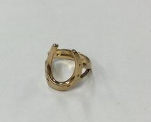 A 9 carat horseshoe shaped signet ring. Approx. 4.