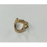 A 9 carat horseshoe shaped signet ring. Approx. 4.