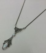 An unusual silver and marcasite pendant on fine li