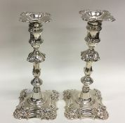 A good pair of George II cast silver candlesticks