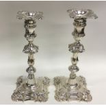 A good pair of George II cast silver candlesticks