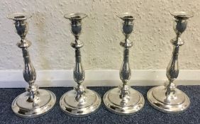 A rare set of four Georgian silver candlesticks wi