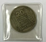 A French silver 20 Franc coin. Est. £10 - £20.