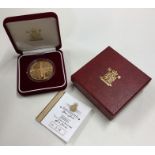 A Queen Elizabeth Alderney proof £5 gold coin. Est