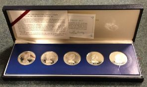 A cased set of five silver proof $25 coins. Est. £