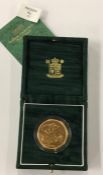 A Royal Mint cased proof 2001 £5 gold coin. Est. £