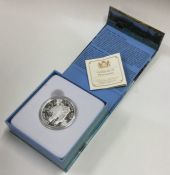 A cased proof silver Canadian $100 coin. Est. £10