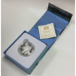 A cased proof silver Canadian $100 coin. Est. £10