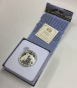 A cased proof silver Canadian $100 coin. Est. £10